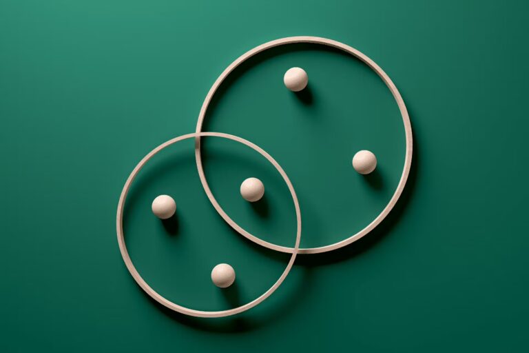 A pair of wooden circles, each topped with two balls, creating a balanced and visually appealing arrangement.